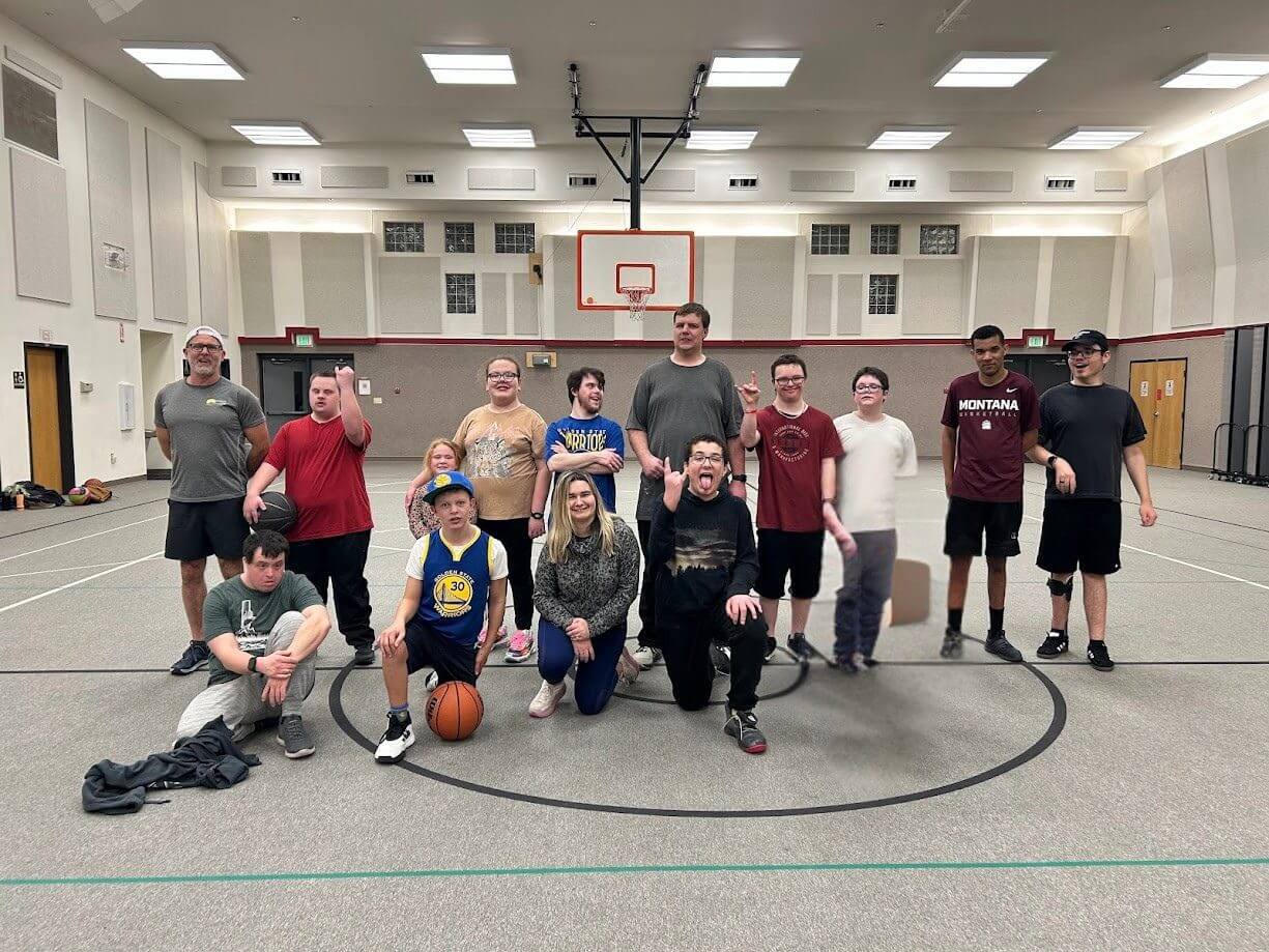 Group posing on indoor basketball court